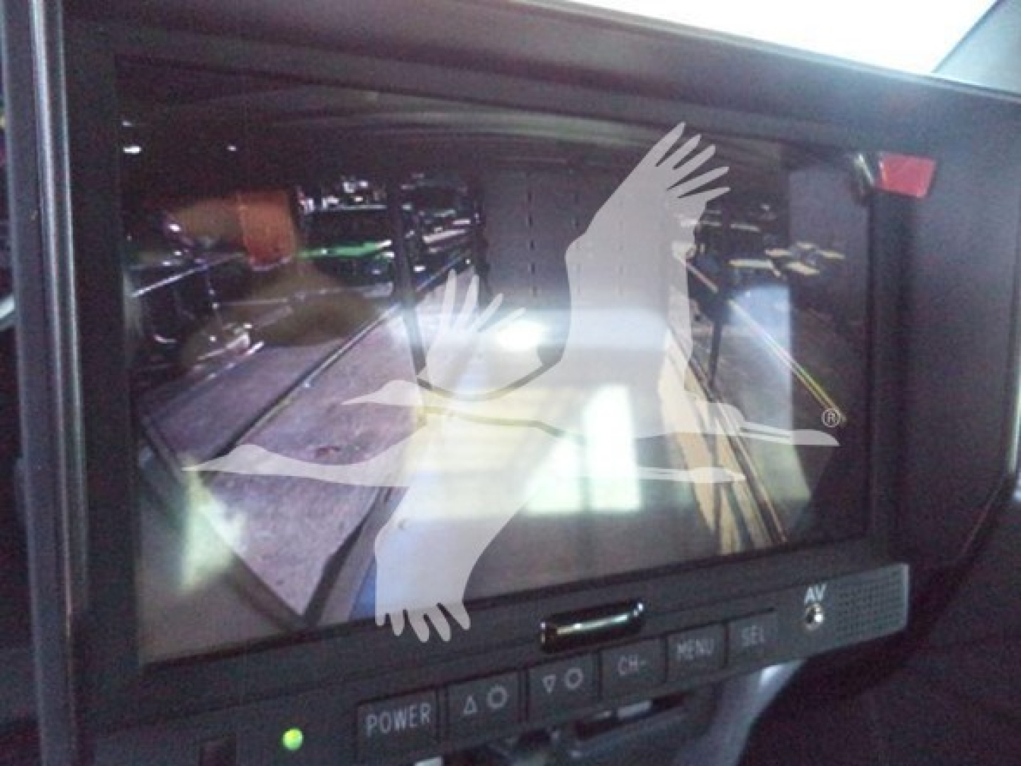 Kenworth truck rollback interior monitor showing controls and a reflection of surroundings.