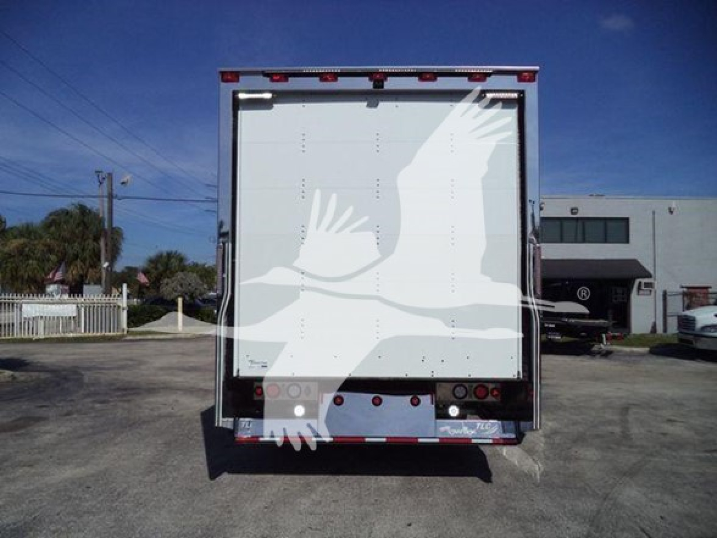 Kenworth T280 rollback truck rear view showing plain tailgate with no visible branding text.