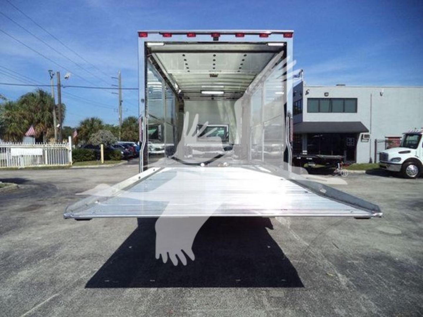 Kenworth T280 rollback truck rear with open cargo area and ramp extended.