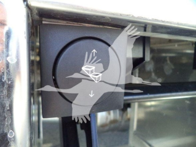 Kenworth T280 truck front emblem area showing circular control or cap with chrome surrounding, partial windshield chrome trim.
