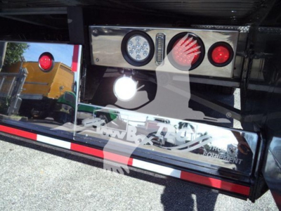Kenworth T280 rollback truck rear bumper with chrome panel and lights. Visible are circular taillights, reverse light, and chrome lettering on bumper, reflections in polished surface.