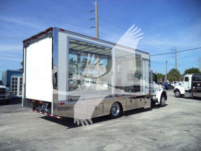 Kenworth T280 rollback truck side view showing cargo box and cab with open side compartment and rear ramp.