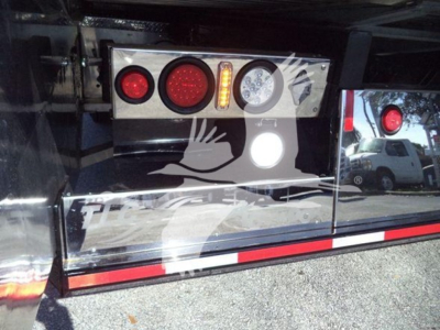 KansasKenworth/Tow truck tail panel with multiple circular lights, rear bumper, and reflective decals. Visible text includes no legible model text; tail light cluster with red and amber lenses.