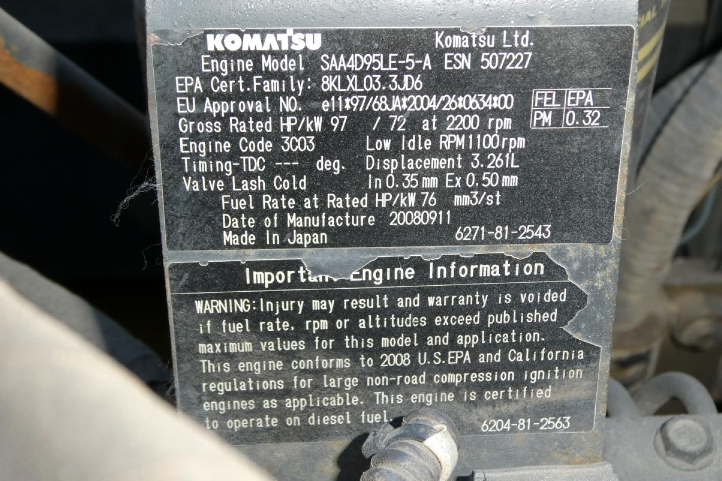 Komatsu engine information label on excavator showing model SAA4D95LE-5? ESA? EPC details, engine code 3003, fuel rate, RPM, displacement 3.26L, valve lash, etc. Includes Made in Japan, important engine information warning block.