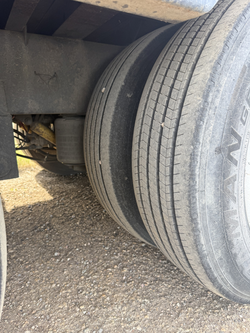 Volvo truck wheel area showing dual rear tires with tread and a portion of the axle housing. Visible markings on the tire read 'HAVAN' or similar partial. No other legible text.
