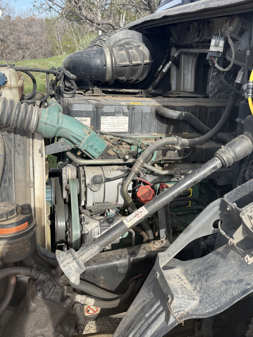 Volvo VNL64T300 engine bay showing diesel engine and various hoses and components.