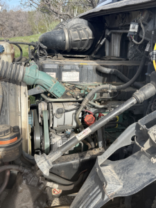 Volvo VNL64T300 engine bay showing diesel engine and various hoses and components.