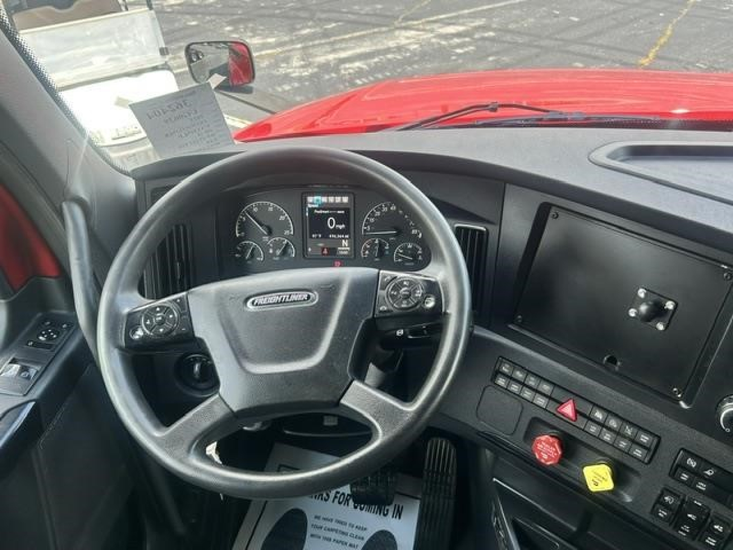 Dashboard and steering wheel of a Freightliner Cascadia 126 sleeper cab showing instrument cluster and center console with touchscreen display.