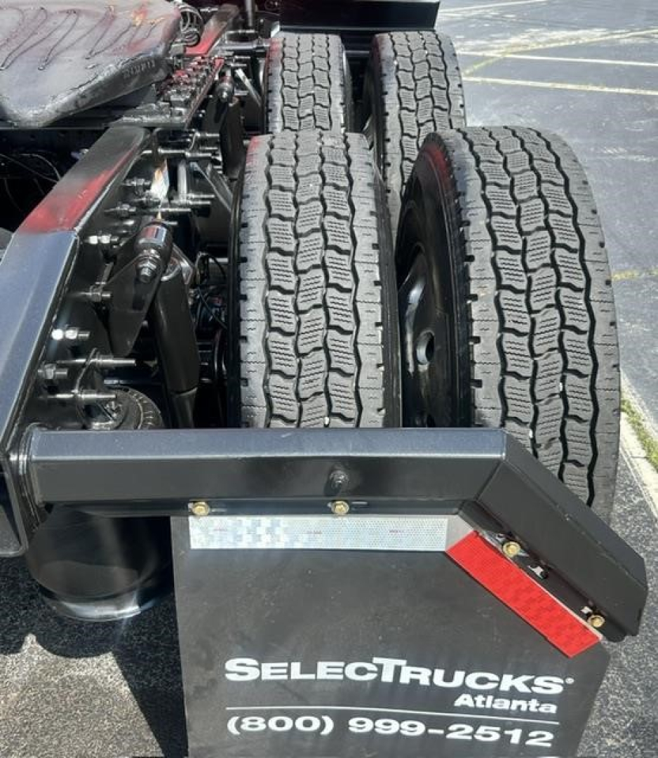 Truck rear showing dual rear axles and chassis components with Select Trucks Atlanta branding on bumper plate, no visible text other than the brand