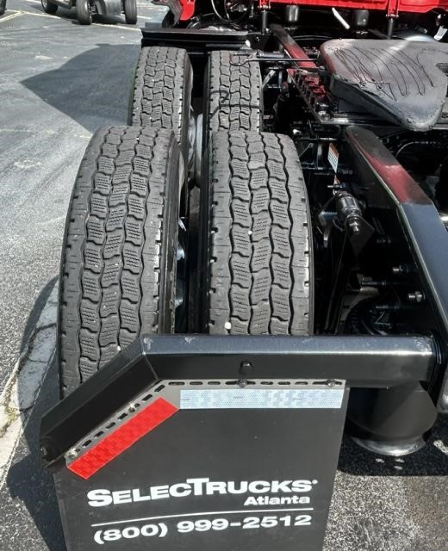 Freightliner Cascadia dual rear tractor tires showing wheel chassis andAdjacent side with SelectTrucks Atlanta branding plate and contact number