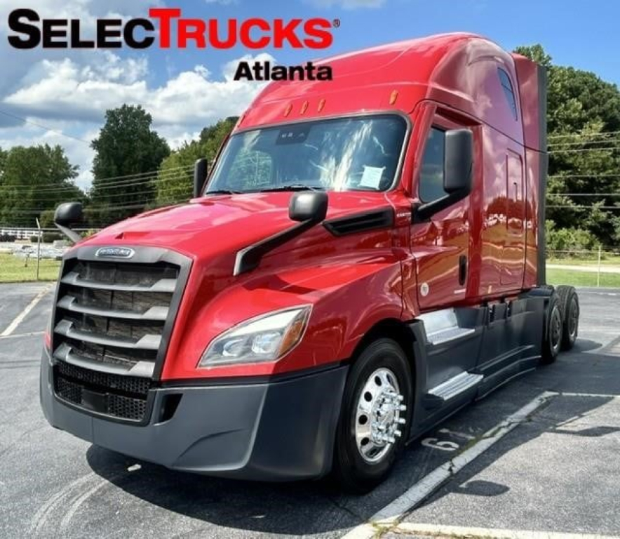 Red Freightliner Cascadia 126 tractor-trailer in a dealership lot with SelectTrucks Atlanta logo