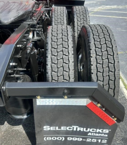 Truck rear showing dual rear axles and chassis components with Select Trucks Atlanta branding on bumper plate, no visible text other than the brand