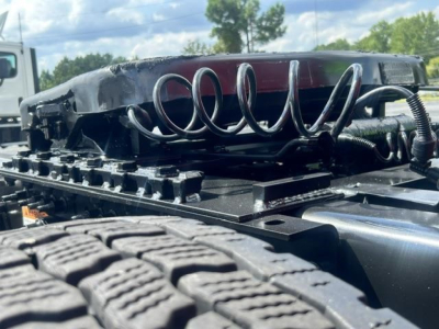 Truck cab and air suspension coil lines with fifth wheel on a Freightliner Cascadia chassis plate showing components