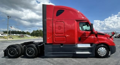 Red Freightliner Cascadia 126 sleeper tractor side view showing long hood, tandem rear axles, and sleeper cab with black chassis and chrome accents.