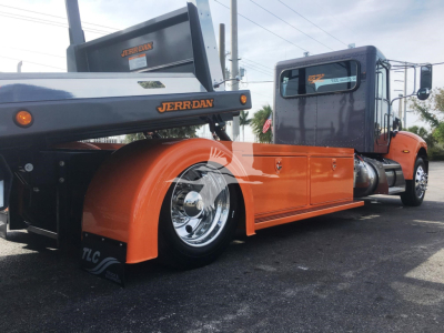 Peterbilt 337 rollback truck side view showing orange fenders and rear wheel.