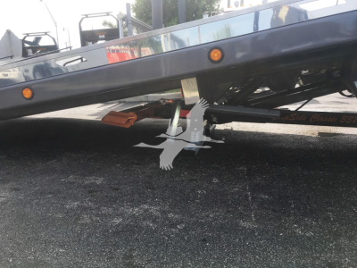 Peterbilt 337 rollback truck undercarriage with support stands and orange clearance lights visible.