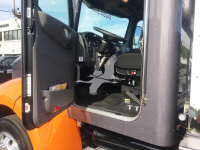 Peterbilt 337 truck cab interior from open door, dashboard and driver seat visible.