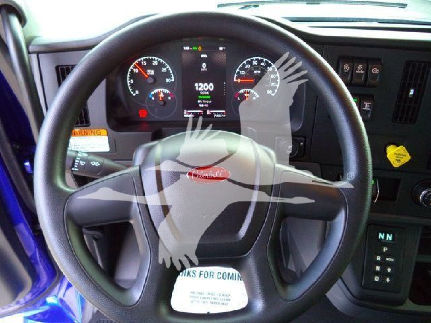 Peterbilt truck dashboard and steering wheel with digital gauge cluster in a new 2025 Peterbilt 536 rollback truck cab.