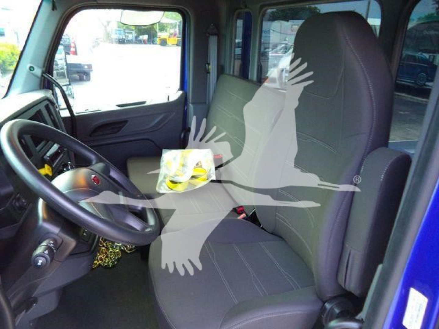 Peterbilt 536 cab interior showing driver's seat and passenger seat with steering wheel and dashboard.