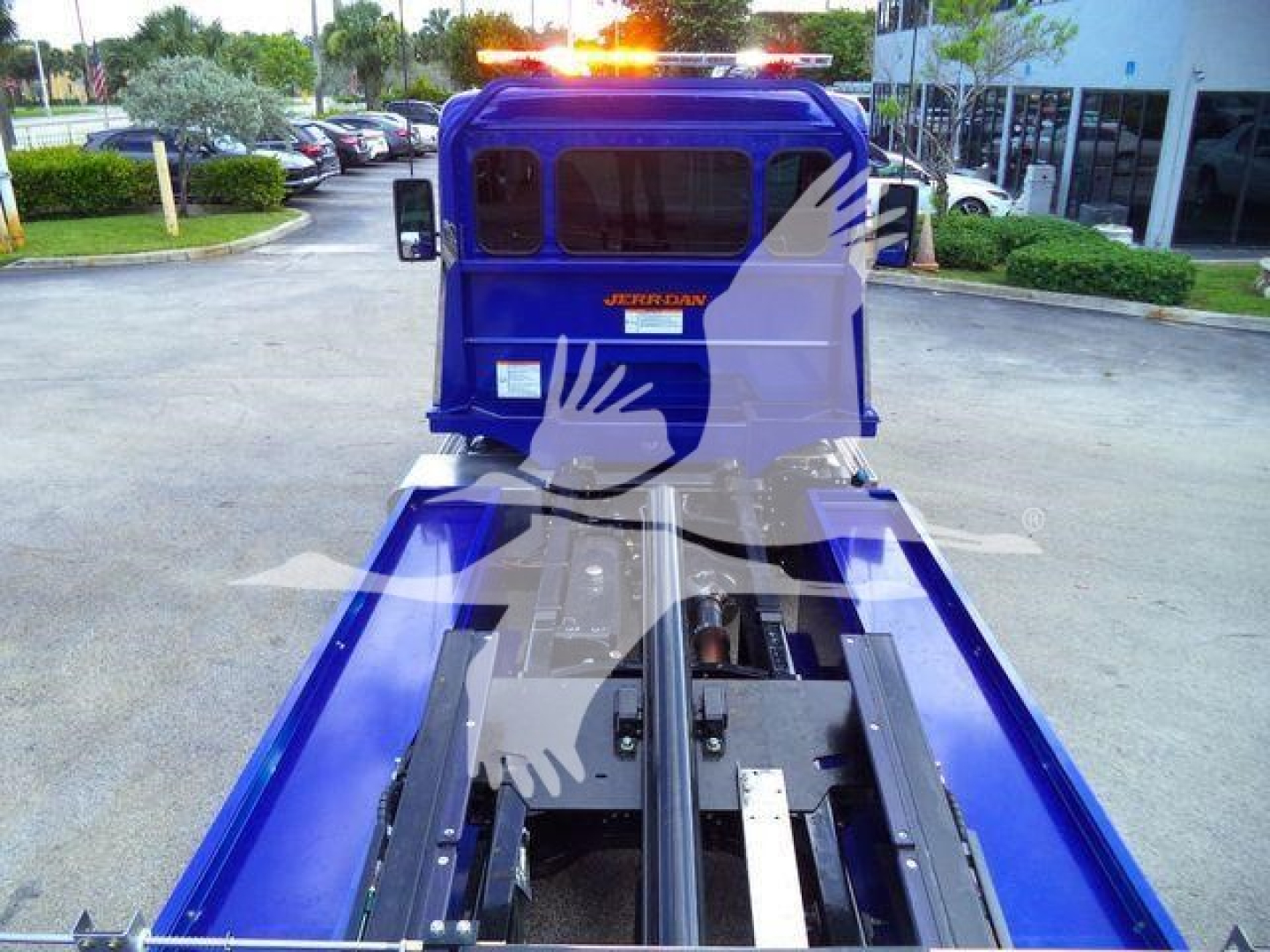 Blue Peterbilt 536 rollback truck cab and chassis showing wide bed and rails.