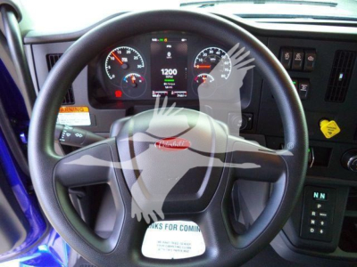 Peterbilt truck dashboard and steering wheel with digital gauge cluster in a new 2025 Peterbilt 536 rollback truck cab.