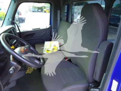 Peterbilt 536 cab interior showing driver's seat and passenger seat with steering wheel and dashboard.