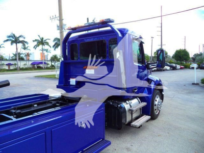Peterbilt 536 truck cab and rollback body in blue, side view, with steps and fuel tank visible.