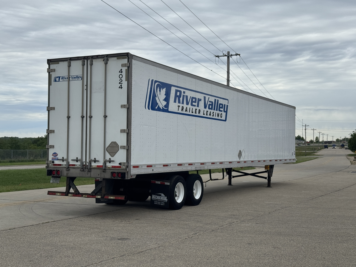 Trailer side and rear showing River Valley Trailer Leasing logo on a white utility 4000Dx trailer, with dual rear doors and Mississippi license style numbers.