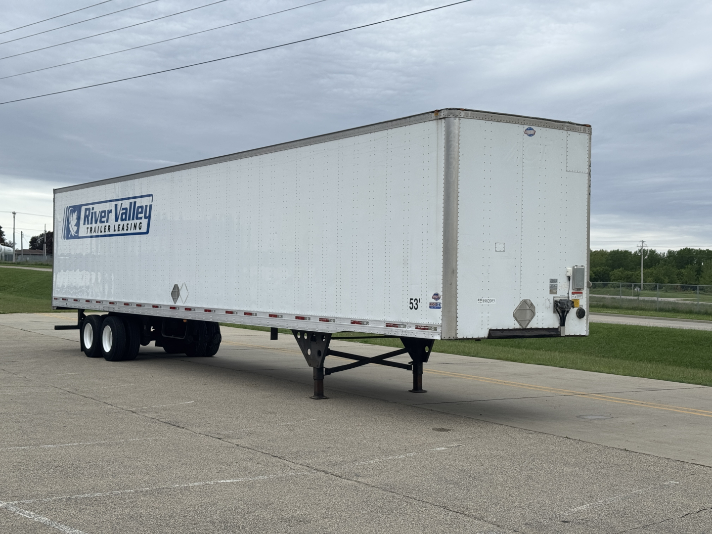 Utility 4000Dx trailer in side view showing River Valley trailer leasing branding on white cargo box with dual rear doors and landing gear.