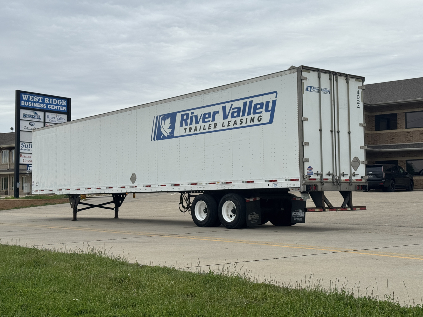Trailer side view showing River Valley Trailer Leasing logo on a white utility trailer.