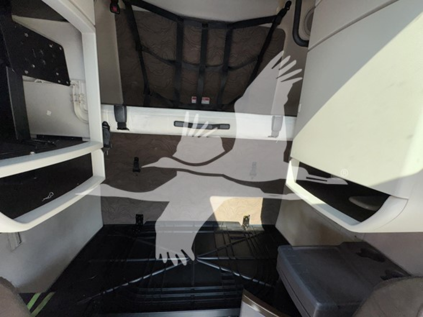 Volvo VNL64T670 truck cab interior floor area with steps and storage compartments visible, no data readable on panels.