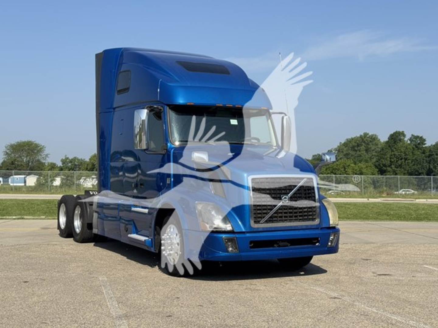 Volvo VNL64T670 tractor-trailer in blue, side view, sleeper cab, no text visible on decals.