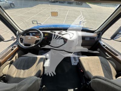 Cab interior of a 2017 Volvo VNL64T670 showing steering wheel, dashboard, two front seats, and center console.