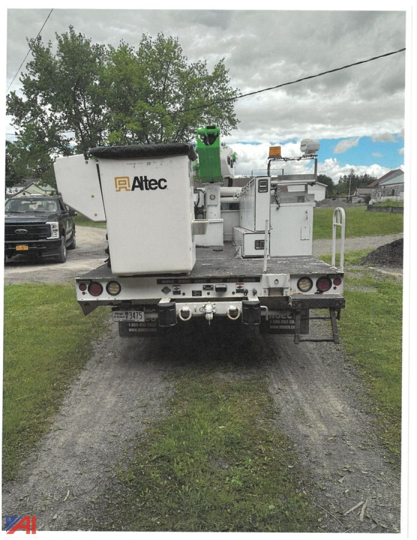 Altec bucket truck rear view showing utility body and equipment with rear step, lights, and stabilizers.
