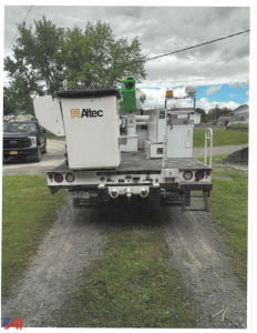 Altec bucket truck rear view showing utility body and equipment with rear step, lights, and stabilizers.