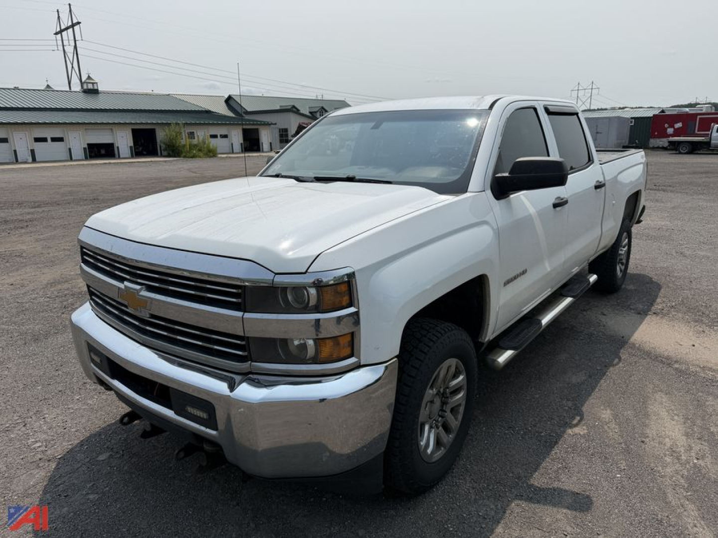 Chevrolet Silverado 2500HD crew cab pickup truck in white, front three-quarter view, chrome bumper, side step bars, in a gravel lot.