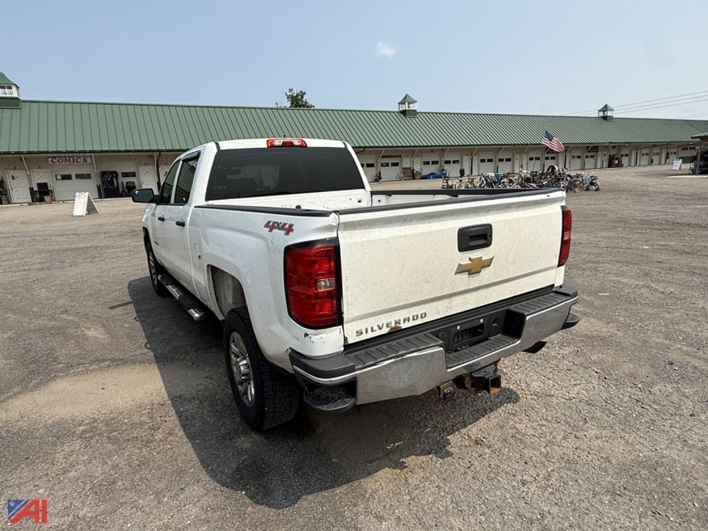 Chevrolet Silverado 2500HD crew cab pickup truck rear view with Silverado badge, Chevrolet bowtie logo, and 4x4 decal on tailgate; hitch and bumper visible.