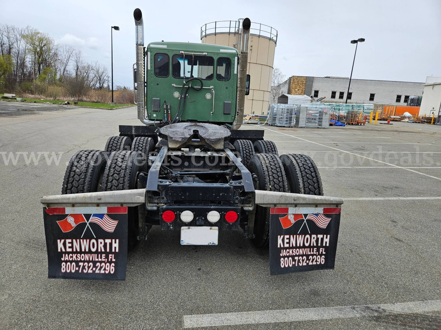 Kenworth T880 rear view showing dual rear axles and mud flaps with Kenworth Jacksonville FL branding.