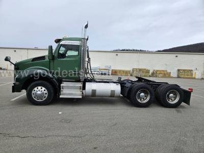 Side view of a green 2017 Kenworth T880 heavy truck tractor chassis with dual rear axles and fuel tanks, VIN 1XKZDK8X5HJ148843, stock 32136-26.