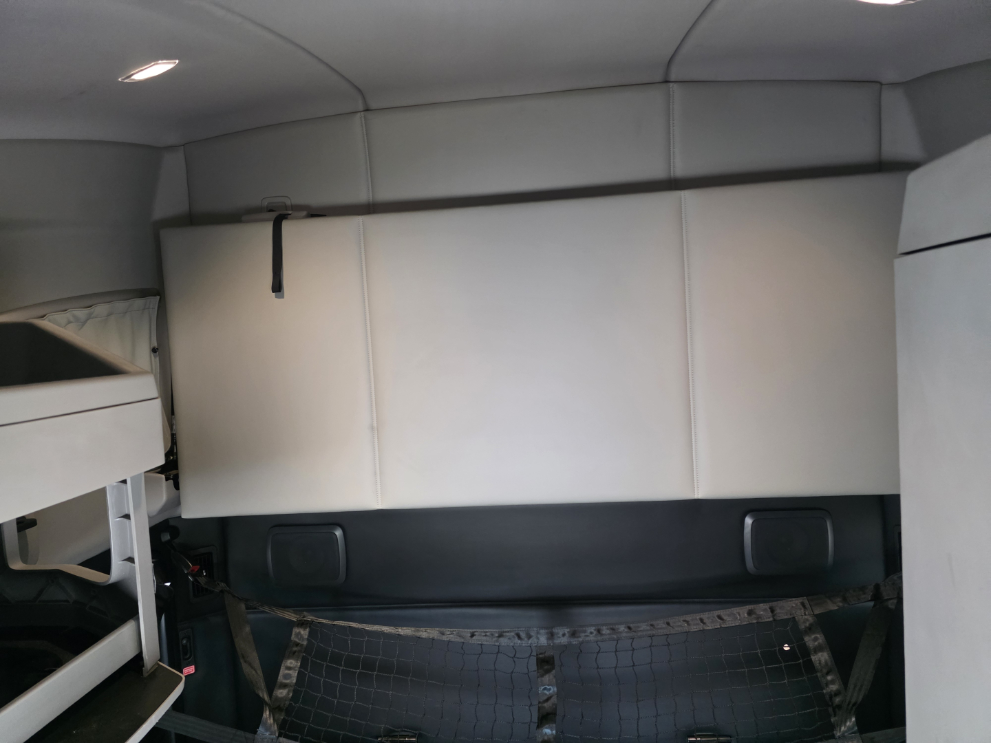 Kenworth T680 sleeper cab interior cargo area with storage box and side panels visible