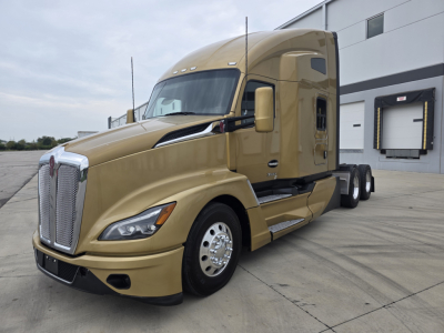 Kenworth T680 diesel truck in gold with sleeper cab, side view showing front grille, hood, and wheels.