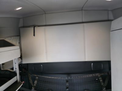 Kenworth T680 sleeper cab interior cargo area with storage box and side panels visible