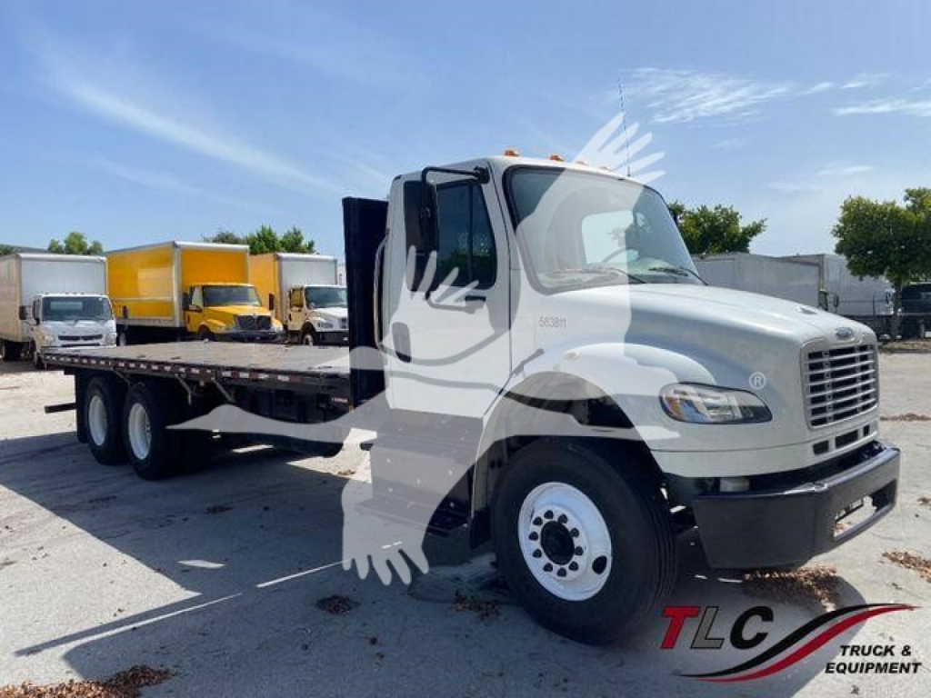 Freightliner M2 106 flatbed truck showing front quarter with extendable flatbed and dual rear axles.