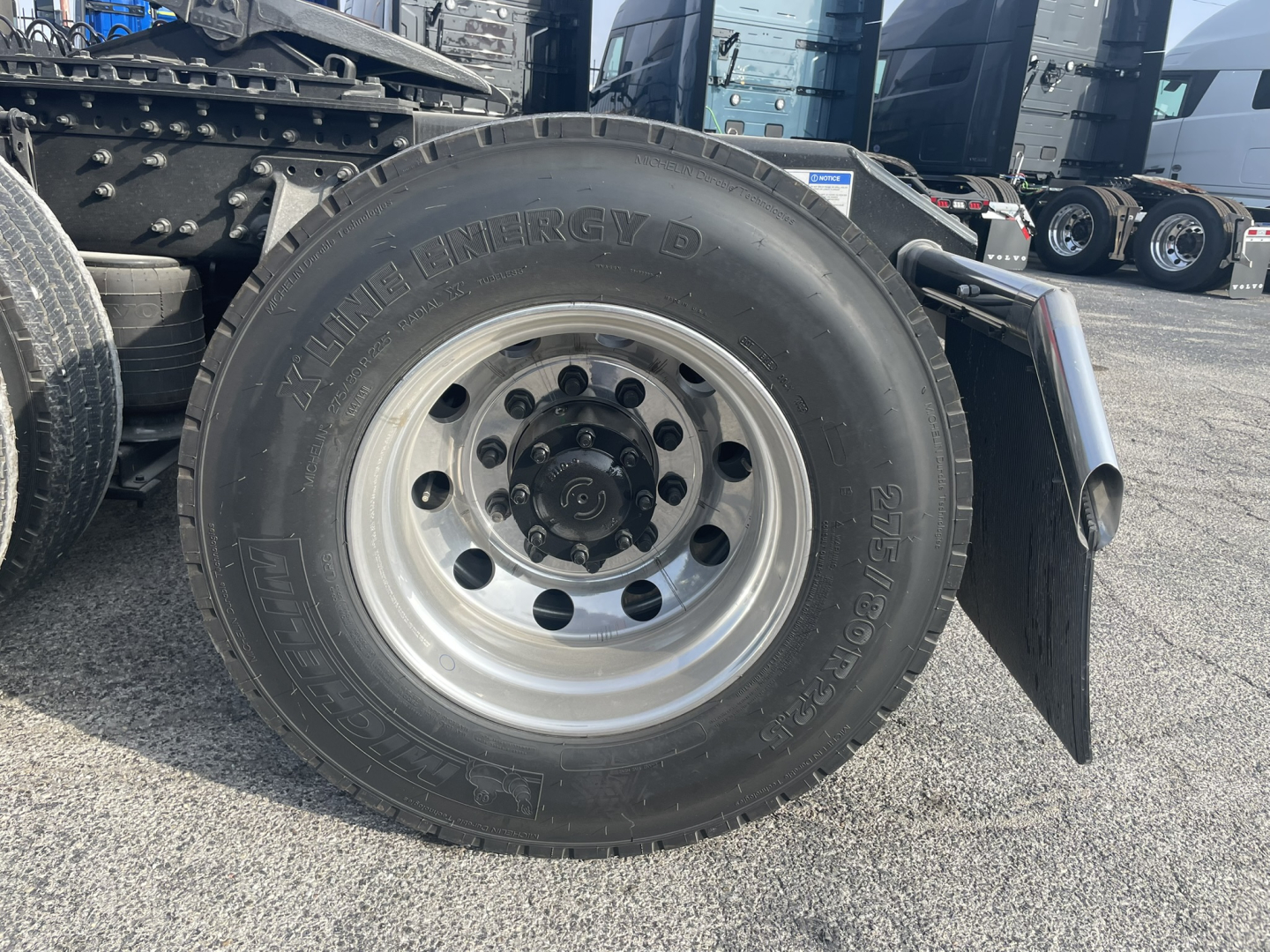 Wheel and tire close-up on a 2026 Volvo VNL truck showing Alpinere? brand tire and wheel with mudguard.