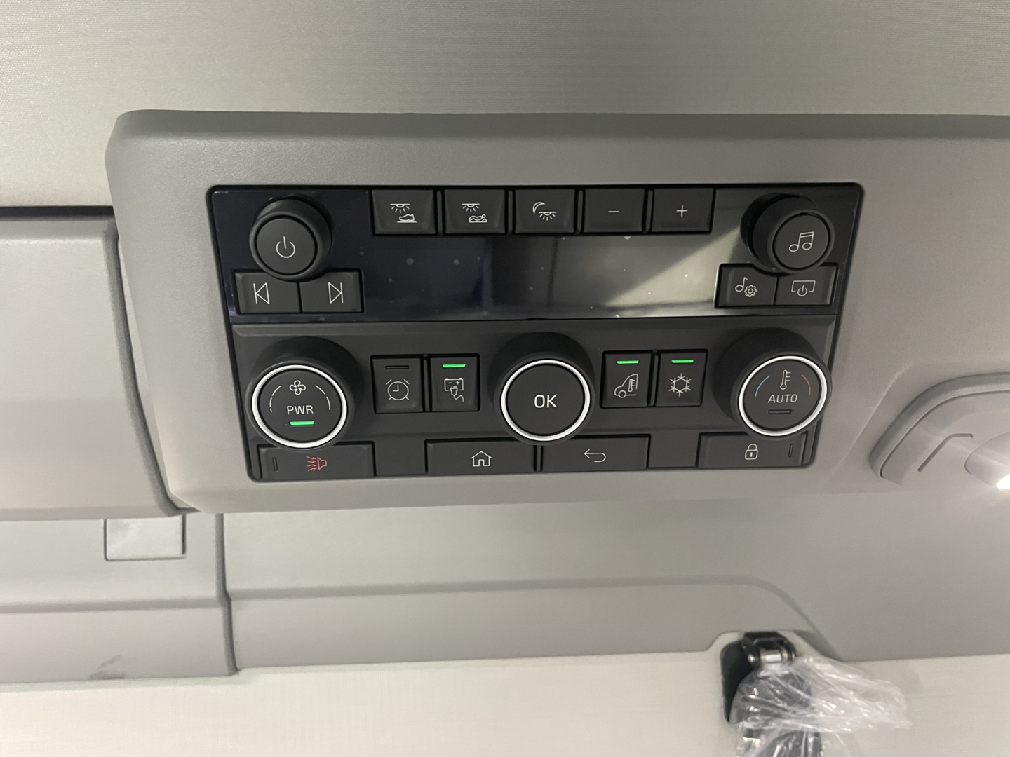 Cab control panel in Volvo VNL64T860 showing various buttons and knobs.