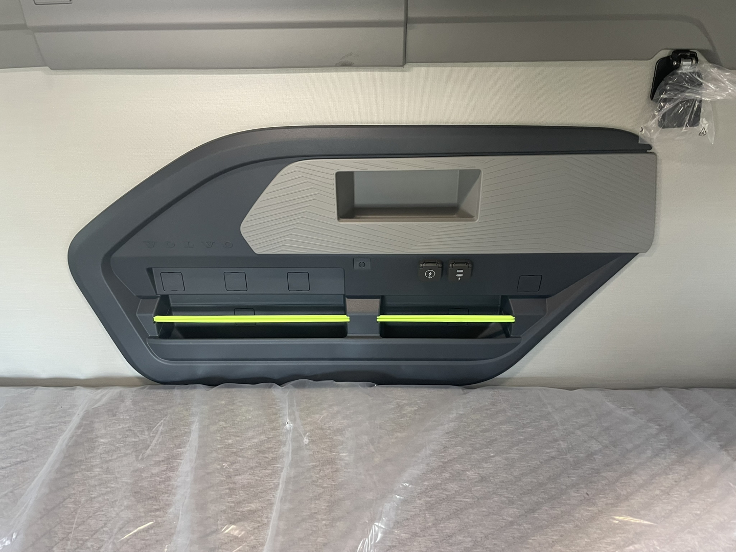 Volvo VNL64T860 interior door panel showing control switches and illuminated green accents.