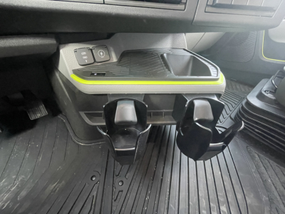 Interior dash area showing cup holders and controls; no visible serials or labels readable.
