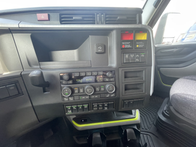Volvo VNL64T860 truck cab interior dashboard showing climate controls, switches, and storage compartment.