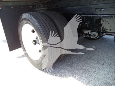 Isuzu NPR HD truck wheel and dual rear axle area showing tire and undercarriage components.