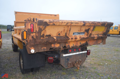 Dump truck bed of a used 2011 Ford F350 Super Duty with rusted bed and tail lights visible.